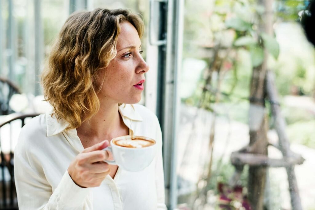 Femme pensive devant son agenda illustrant l'attente passive après l'arrêt de la pilule